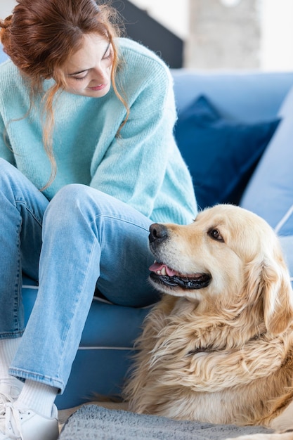 Medium shot woman looking at dog