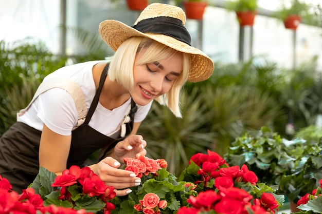 Free photo medium shot woman looking at flowers