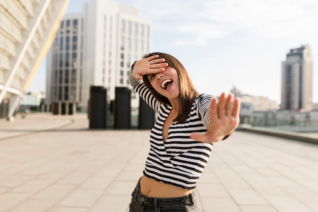 Medium shot woman looking happy outdoors