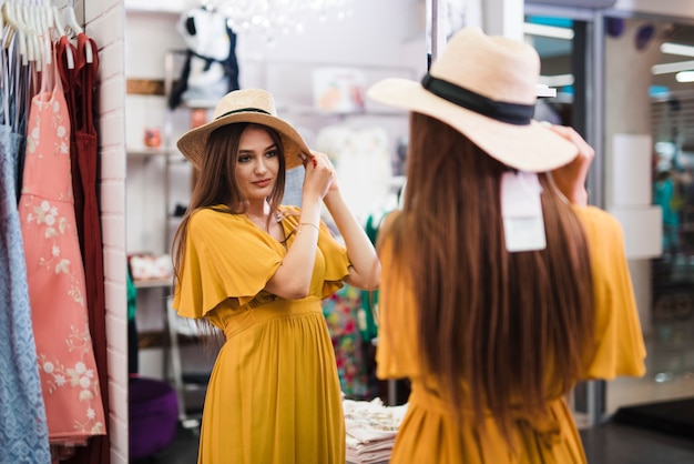 Free photo medium shot woman looking in a mirror