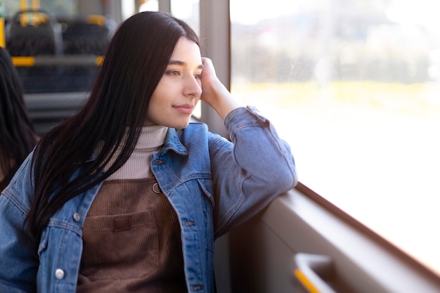 Medium shot woman looking out the window