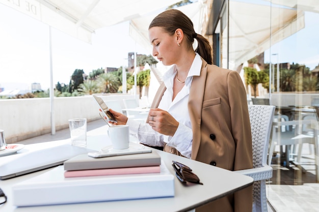 Medium shot woman looking at phone