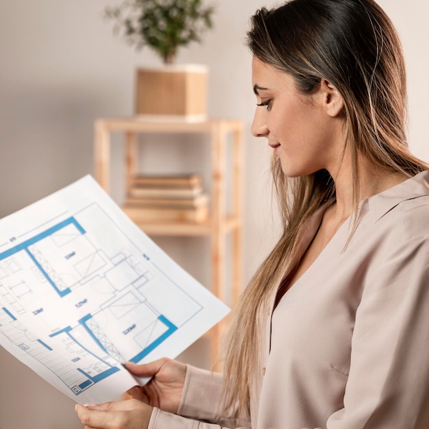 Medium shot woman looking at plan