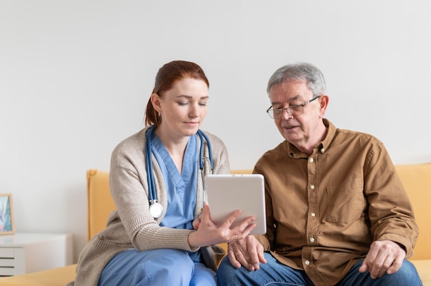 Medium shot woman and man with tablet