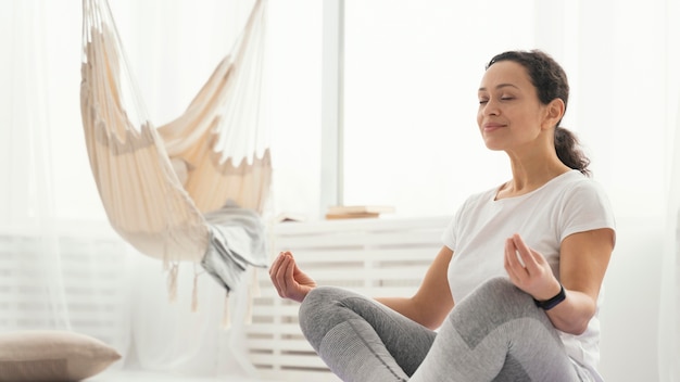 Medium shot woman meditating