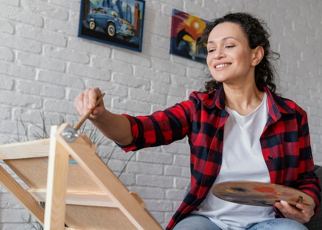 Medium shot woman painting at home