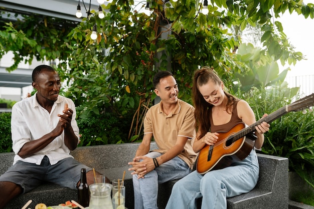 Free photo medium shot woman playing the guitar