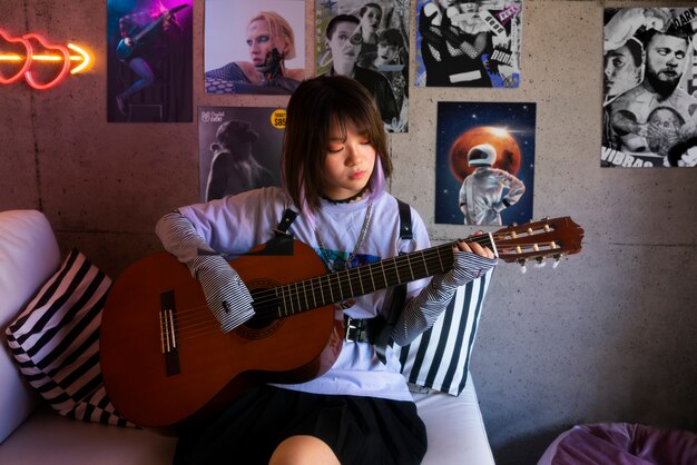 Medium shot woman playing the guitar