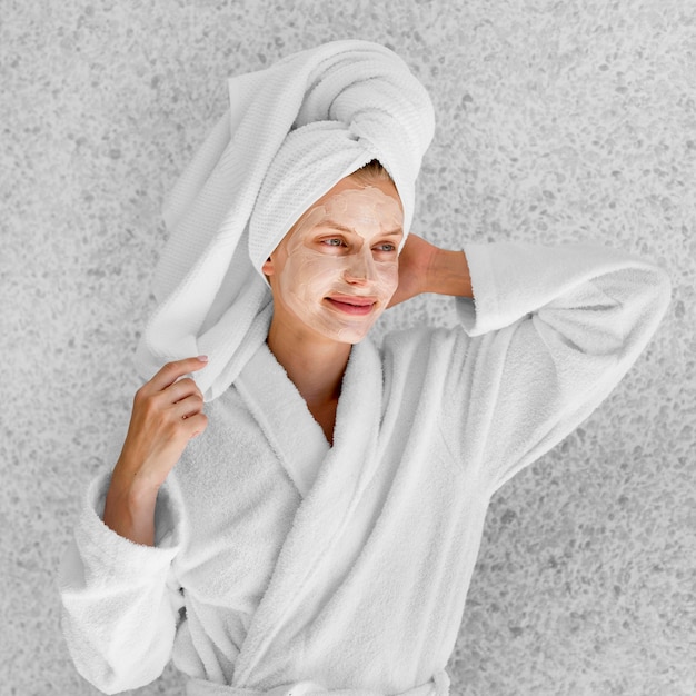 Free photo medium shot woman posing in bathrobe