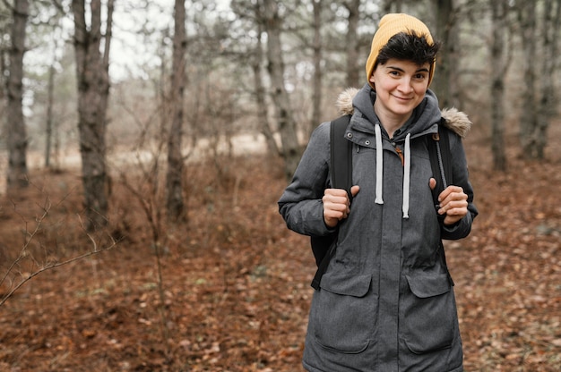 Medium shot woman posing in forest