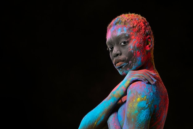 Free photo medium shot woman posing with colorful powder