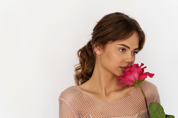 Medium shot woman posing with flower