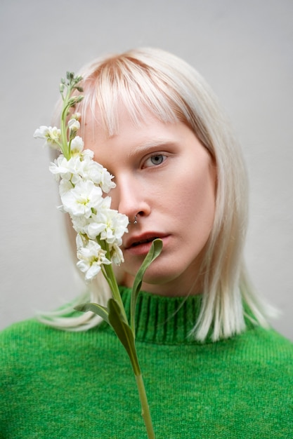 Free photo medium shot woman posing with flower