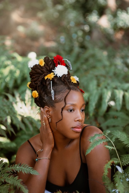 Medium shot woman posing with flowers