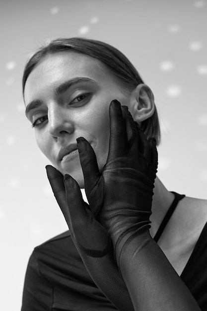 Free Photo medium shot  woman posing with gloves black and white