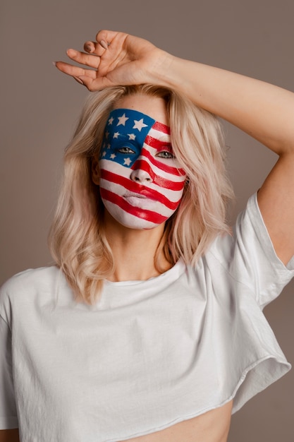 Free photo medium shot woman posing with usa makeup