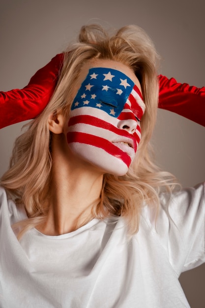 Free photo medium shot woman posing with usa makeup