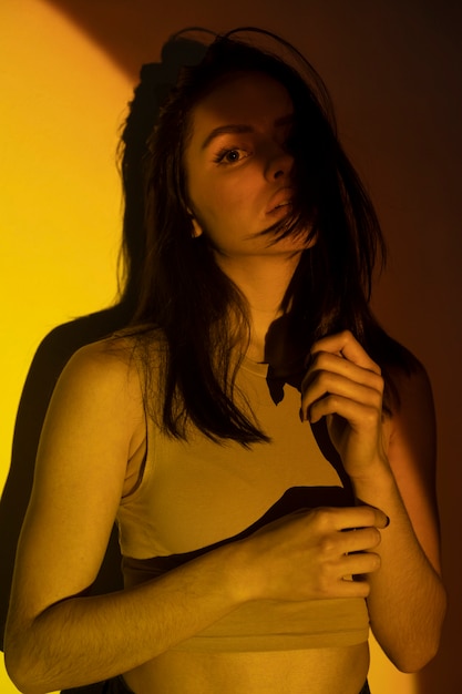 Medium shot woman posing with yellow light