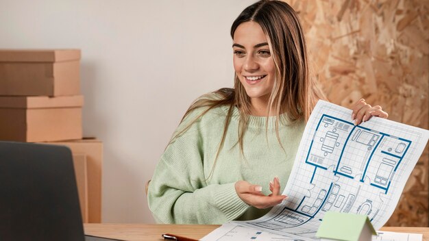 Medium shot woman presenting plans