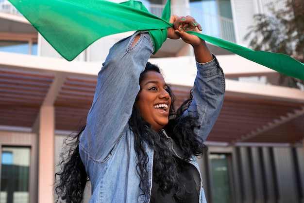 Free Photo medium shot woman protesting outdoors