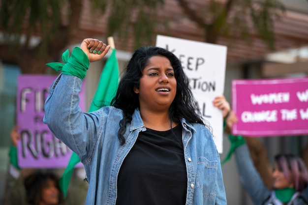 Medium shot woman protesting outdoors