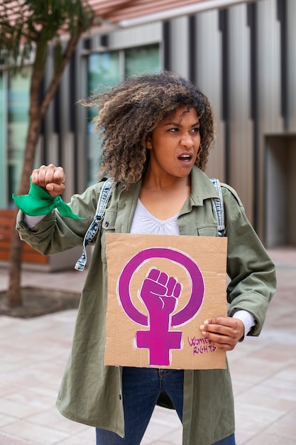 Medium shot woman protesting outdoors