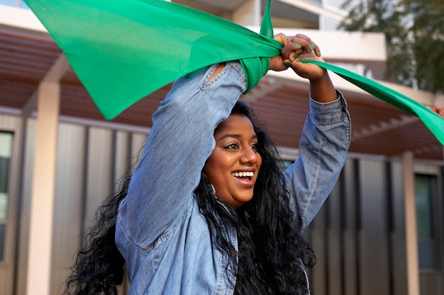 Medium shot woman protesting outdoors