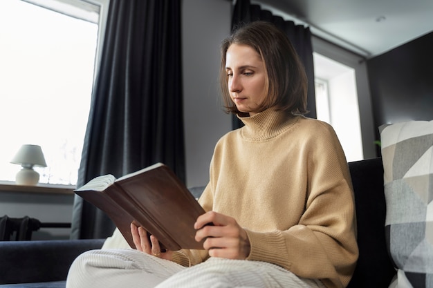 Medium shot woman reading bible