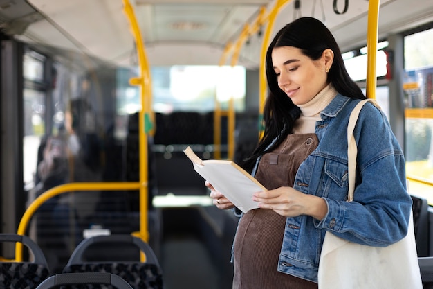 Medium shot woman reading book