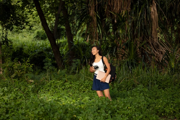 Medium shot woman ready to take photos