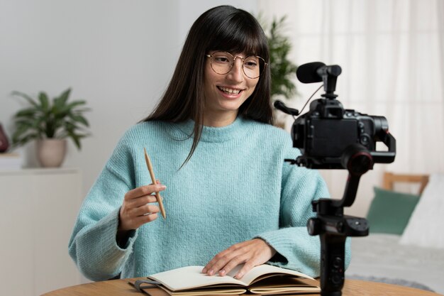 Medium shot woman recording herself