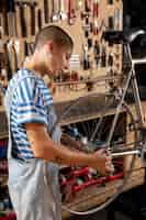 Free photo medium shot woman repairing bicycle