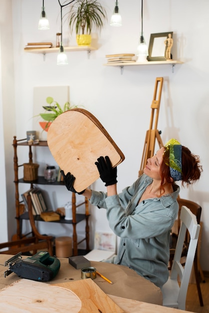 Free photo medium shot woman restoring furniture