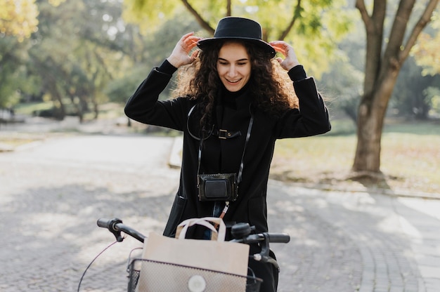 Medium shot woman riding the bicycle