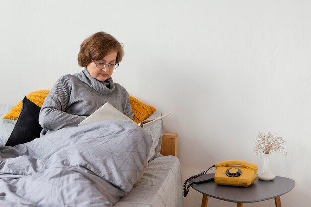 Medium shot woman sitting in bed