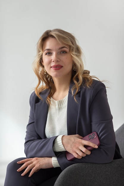 Free Photo medium shot woman sitting on couch