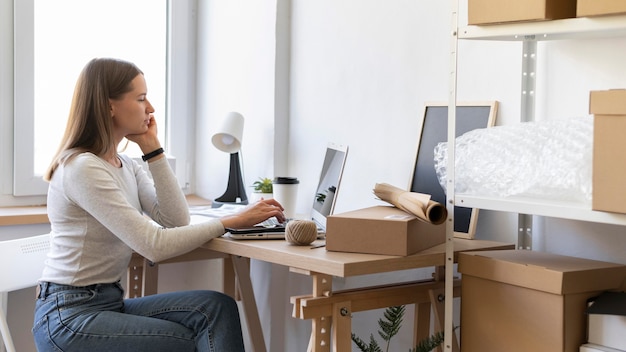 Medium shot woman sitting at desk