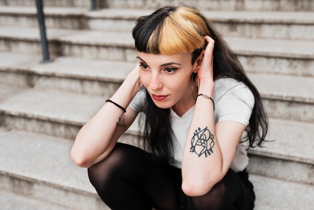 Medium shot woman sitting on stairs