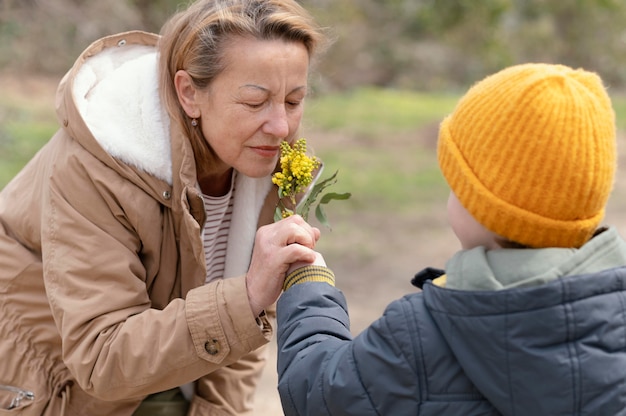 Free Photo medium shot woman smelling flowers