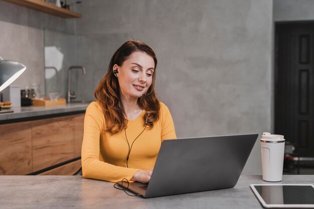 Medium shot woman streaming in kitchen