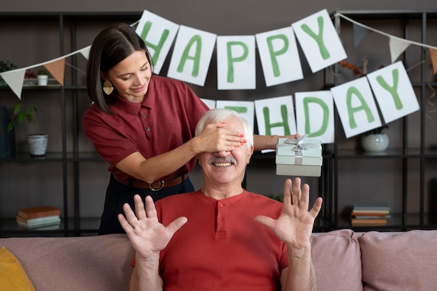 Medium shot woman surprising senior man