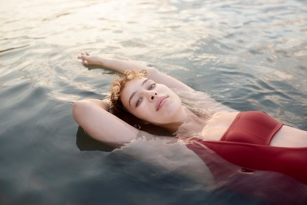 Free photo medium shot woman swimming in vacation