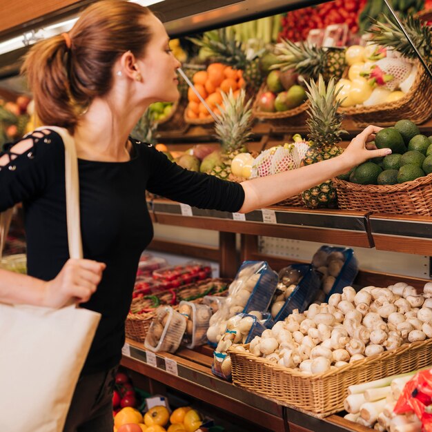 Medium shot woman taking an avocado