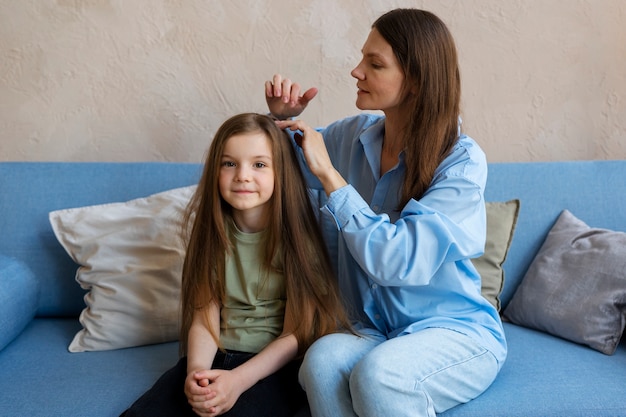 Free Photo medium shot woman taking care of girl