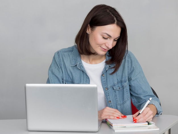 Medium shot woman taking notes