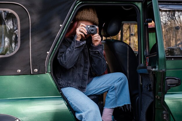 Medium shot woman taking photos