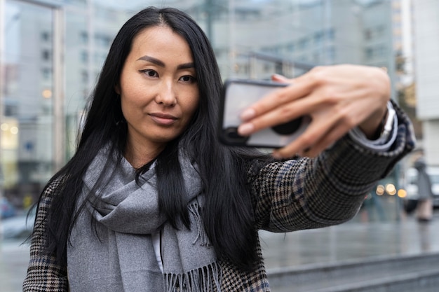 Medium shot woman taking selfie