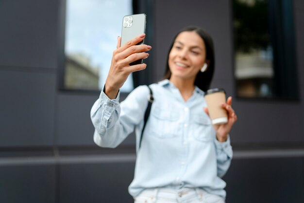 Medium shot woman taking selfie