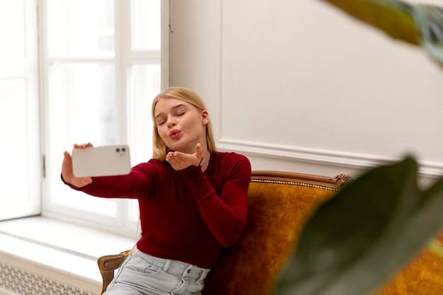 Medium shot woman taking selfie