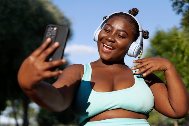 Medium shot woman taking selfie